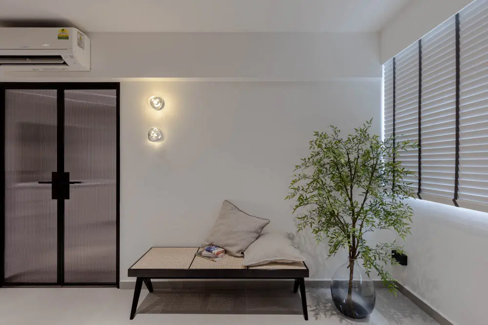 Sculptural bench nook with a slender indoor tree