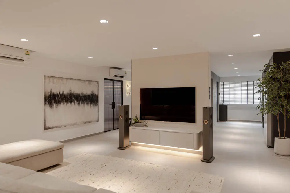 Open-concept living area with a sculptural TV feature wall