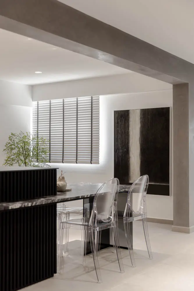 Suspended glass dining table with ghost chairs